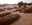 People gather as victims from a collapsed gold mine are buried on Dec. 28, 2021 in Kordofan, Sudan.
