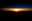 Sunrise - Philippine Sea: An astronaut aboard the International Space Station (ISS) took this photograph of the partial disc of the Sun just as it began to rise, creating a sheet of light across the horizon. Silhouetted clouds give the sense of a jumbled mountain range. Numerous individual layers of the atmosphere appear above the Sun from this perspective.