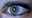 In this file illustration picture, the Twitter logo is seen reflected in the eye of a woman in Berlin. November 7, 2013.