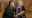 Yulia Kharitonova (92) and Rozalina Kharitonova (94) sitting together on couch.