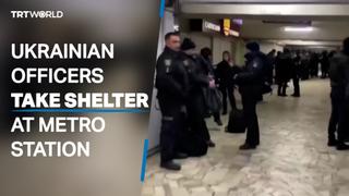 Ukrainian security officers take shelter in Kharkiv metro station