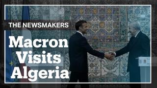 Why did Emmanuel Macron visit Algeria?