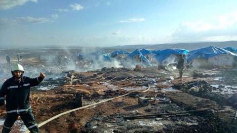 Air strikes hit refugee camp in northern Syria, kill dozens