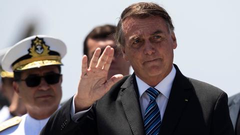 Tearful Bolsonaro leaves Brazil for US, avoiding presidential handover