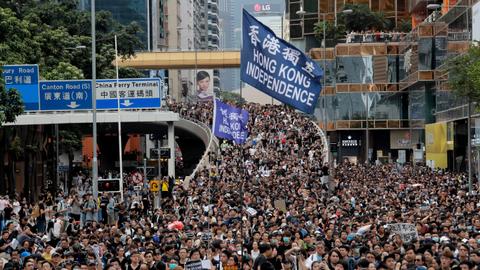 Hong Kong protesters march with mock coffin of city leader