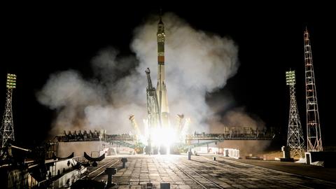 Russian capsule carrying three docks with space station