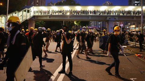 Police fire tear gas as Hong Kong protesters block roads