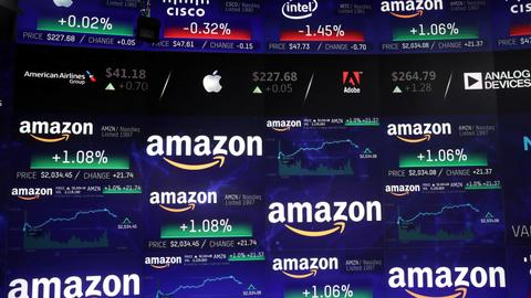 Nasdaq tops 9,000 on boosts from Amazon, trade optimism