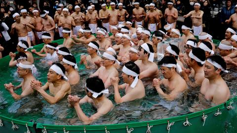 People take icy cold dip at Tokyo shrine to purify their souls for New Year