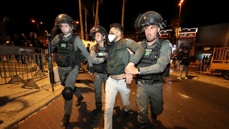 Israeli police officers detain a Palestinian man during clashes, as the Muslim holy fasting month of Ramadan continues, in Jerusalem, April 22, 2021.