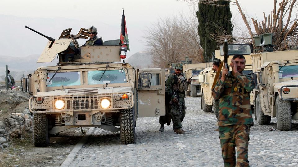In this file photo, Afghan National Army soldiers inspect the site of a car bomb attack on a military base in Shirzad district of Nangarhar province, Afghanistan on January 30, 2021.