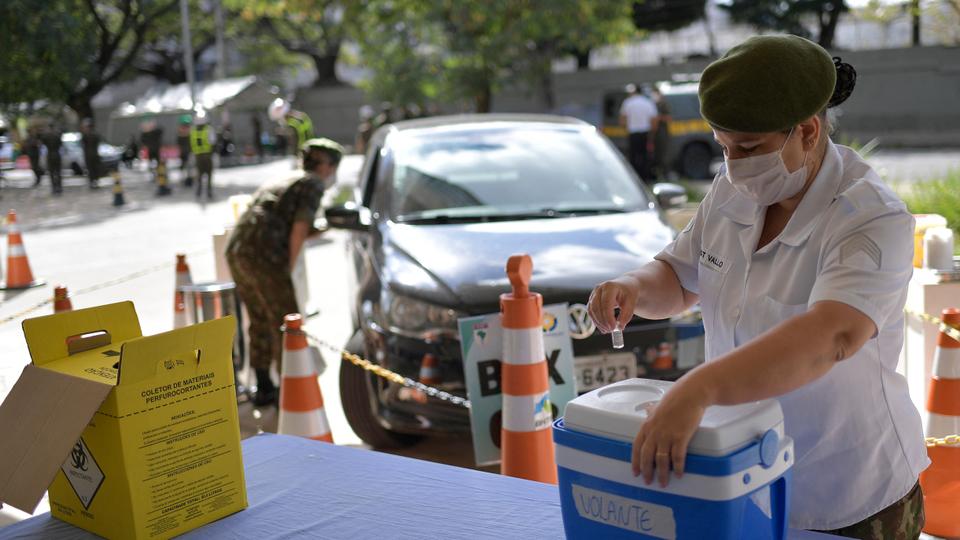 Military personnel  attend a drive-through vaccination centre to inoculate elderly in Belo Horizonte, State of Minas Gerais, Brazil, on May 1, 2021.