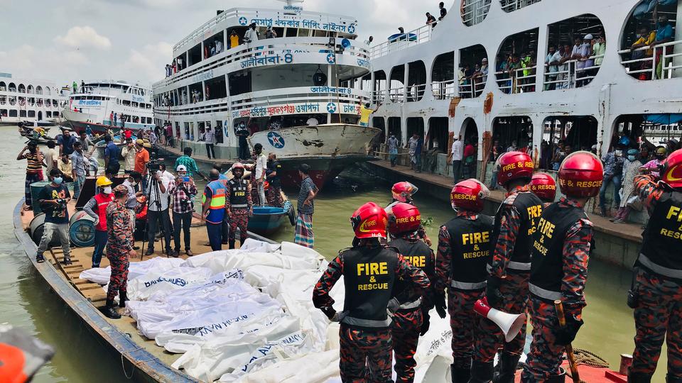 FILE PHOTO: Fire personnel stand in a boat next to the bodies of passengers recovered from Buriganga River in Dhaka, Bangladesh, on June 29, 2020.