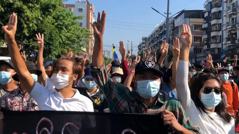 Protesters making the three-finger salute during flash mob as part of demonstrations against the military coup in Yangon, on May 2, 2021