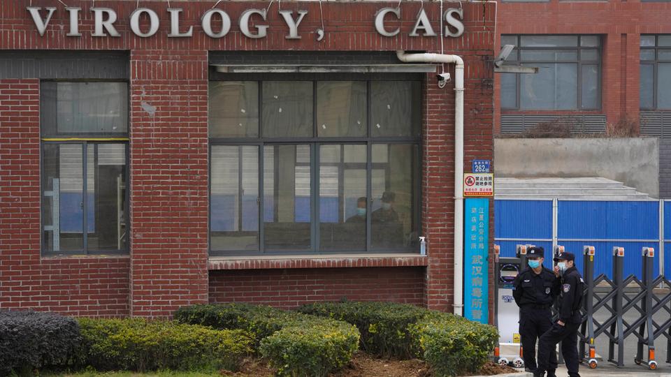 Security personnel gather near the entrance of the Wuhan Institute of Virology during a visit by the World Health Organization team in Wuhan, China, February 3, 2021
