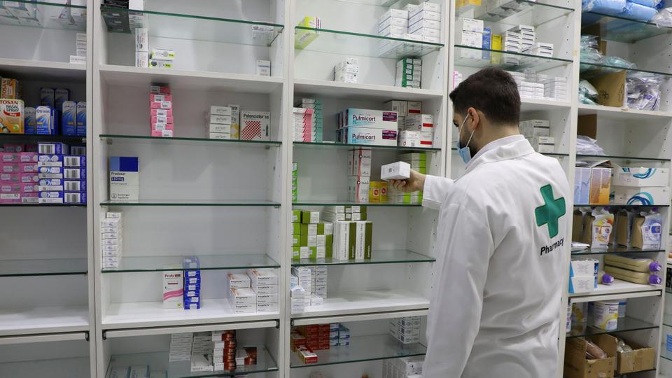 A pharmacy employee holds a box of medication in Beirut, Lebanon, May 28, 2021.