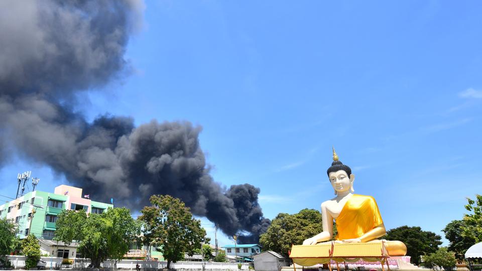 Rising smoke is seen behind the giant Buddha statue in Samut Prakan province, Thailand, Monday, July 5, 2021.