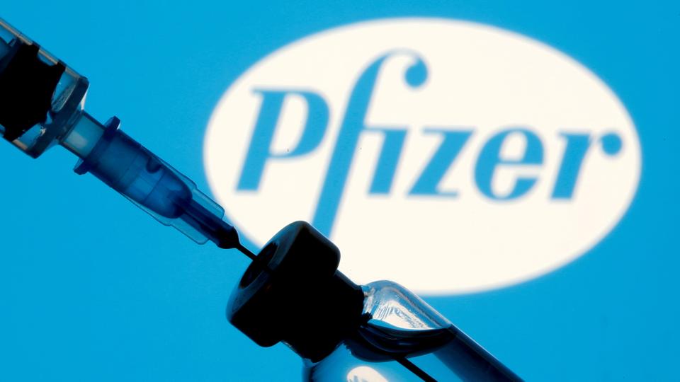 FILE PHOTO: A vial and syringe are seen in front of a Pfizer logo in this illustration taken on January 11, 2021.