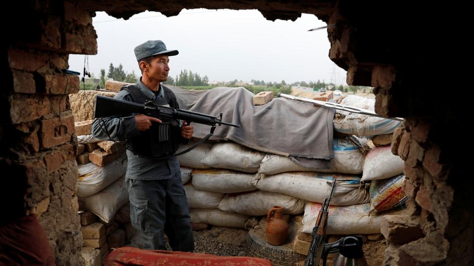 An Afghan policeman keeps watch at the checkpost on the outskirts of Kabul, Afghanistan on July 13, 2021.