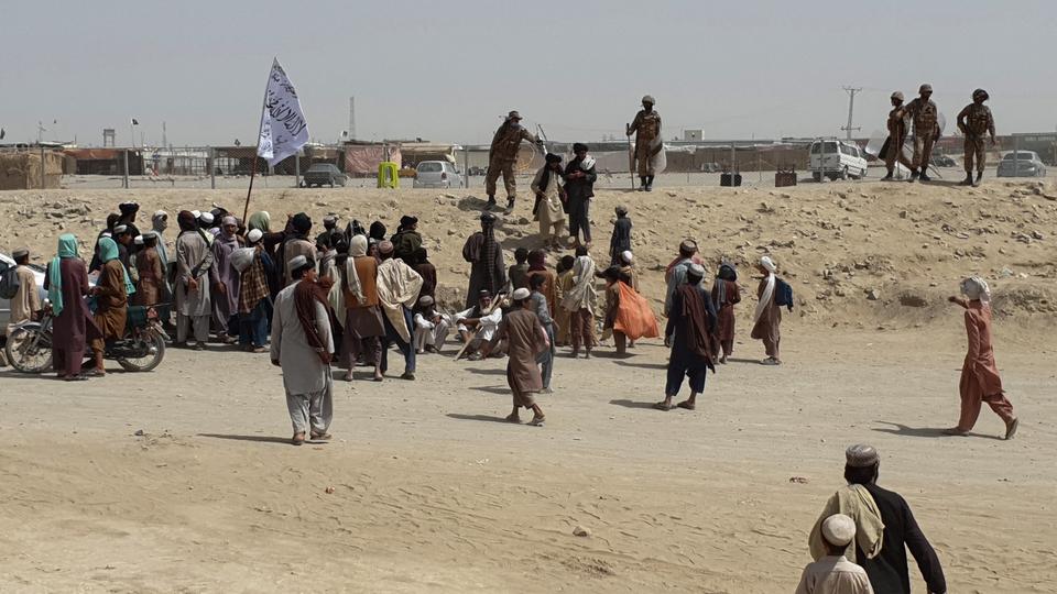 Pakistani border guards disperse stranded people gathered near a border crossing between Afghanistan and Pakistan in Chaman on July 15, 2021.