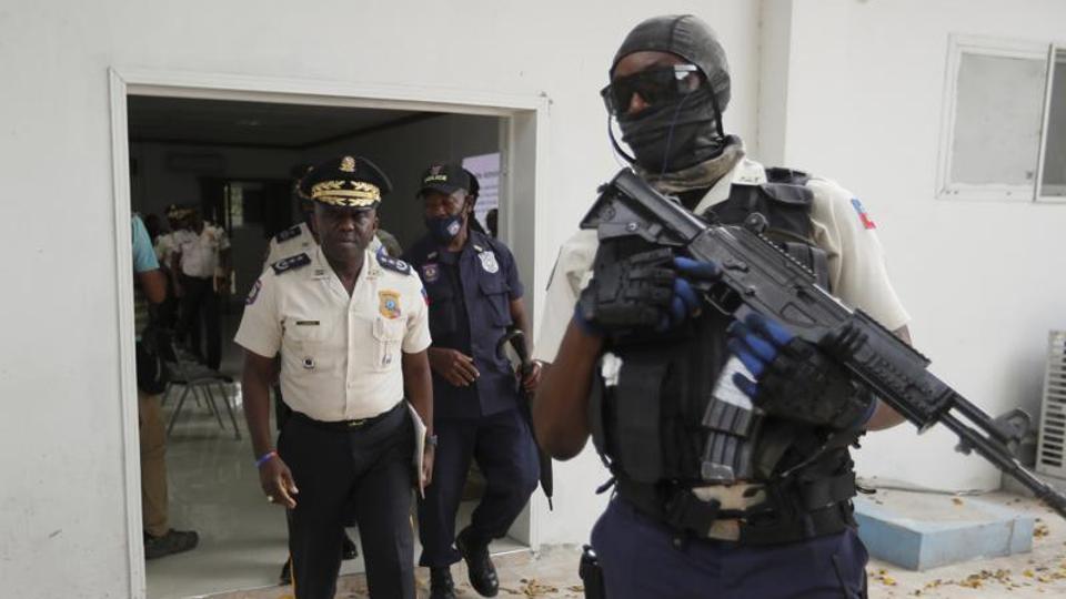 Leon Charles, (L), director general of Haiti's police, leaves a room after a news conference at police headquarters in Port-au-Prince, July 14, 2021.