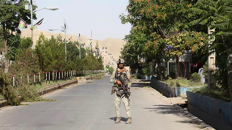 An Afghan security forces personnel stands guard amid ongoing fighting with Taliban fighters in the city of Qal-e-Naw, capital of Badghis province, July 8, 2021.