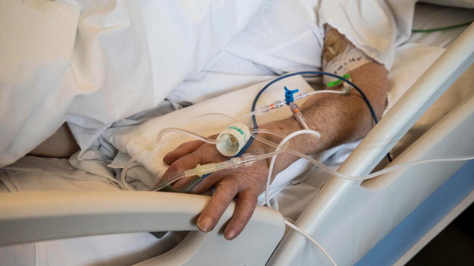 A patient under treatment lies on a bed in the emergency Covid-19 ward at the Mellino Mellini hospital in Chiari, northern Italy, March 8, 2021.