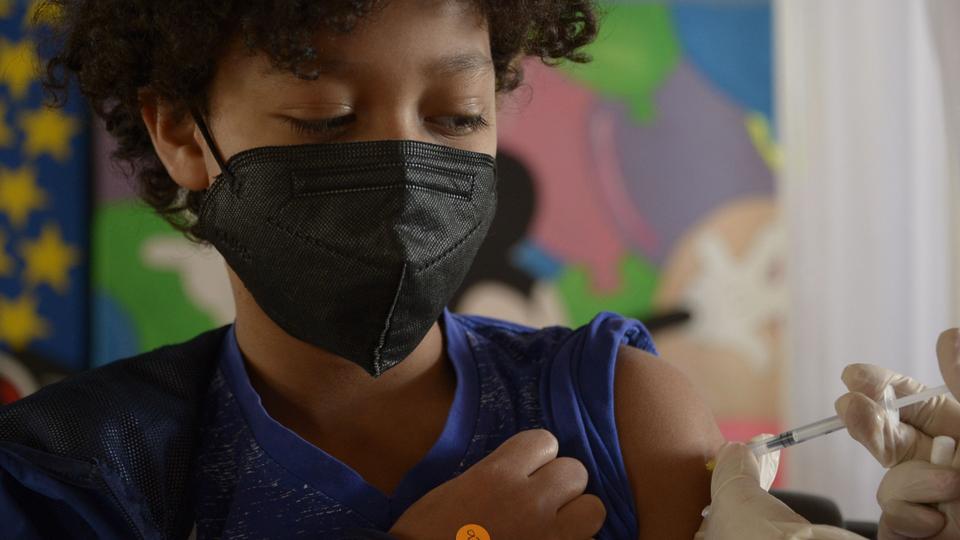 A teenager receives a dose of the Pfizer-BioNTech Covid vaccine at the Cecilia Rivadeneira Foundation in Quito, Ecuador on July 21, 2021.