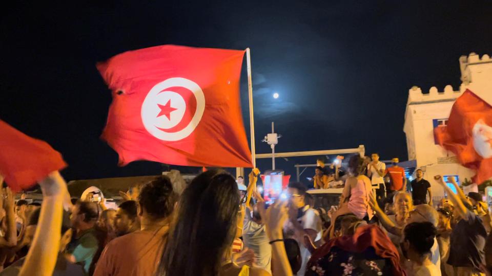 People react in the street after Tunisia's president dismissed the government and froze parliament, in La Marsa, Tunisia, July 26, 2021