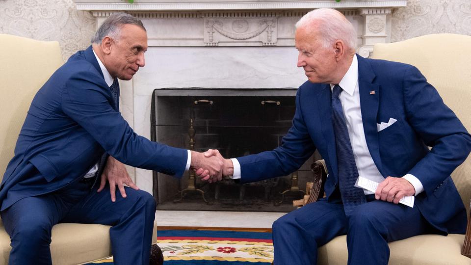 US President Joe Biden shakes hands with Iraqi Prime Minister Mustafa al Kadhimi (L) in the Oval Office of the White House in Washington, DC on July 26, 2021.