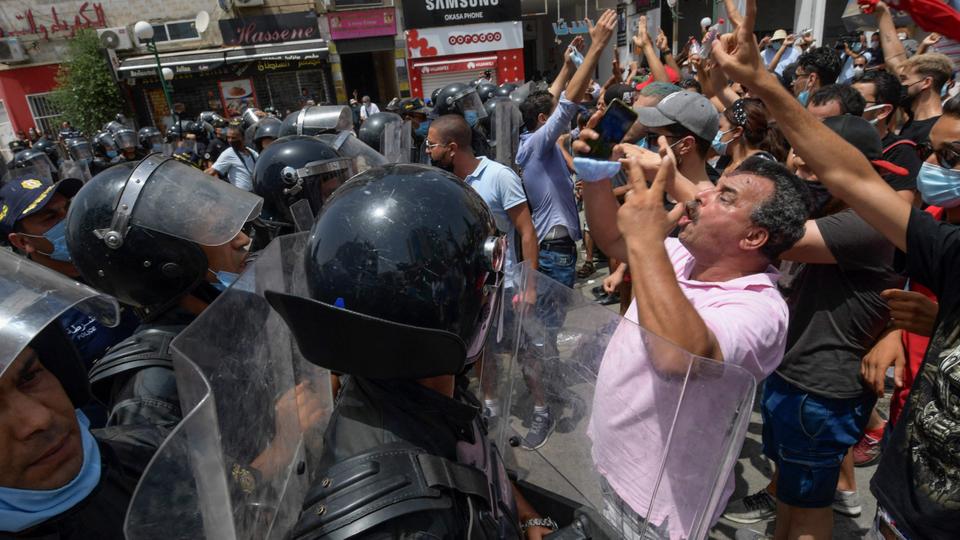 Members of Tunisian security forces face off with anti-government demonstrators during a rally in front of the Parliament in the capital Tunis on July 25, 2021.