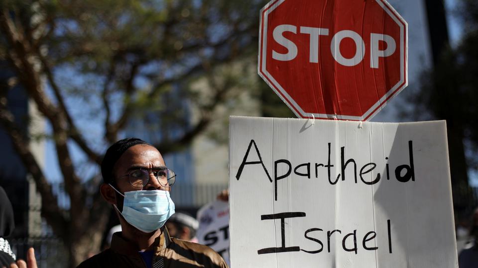 South African demonstrators hold placards during a protest following a flare-up of Israeli-Palestinian violence, outside the Israel Trade offices in Sandton, South Africa