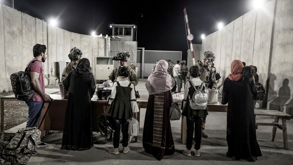 US Army soldiers with the 82nd Airborne Division check evacuees during an evacuation at Hamid Karzai International Airport, Kabul, Afghanistan, August 25, 2021. US Marine Corps/Staff Sgt. Victor Mancilla/Handout via