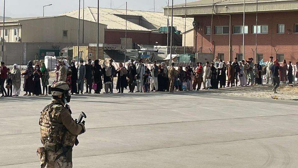 Afghan evacuees queue before boarding one of the last Italy's military aircraft C130J during evacuation at Kabul's airport, Afghanistan, August 27, 2021.