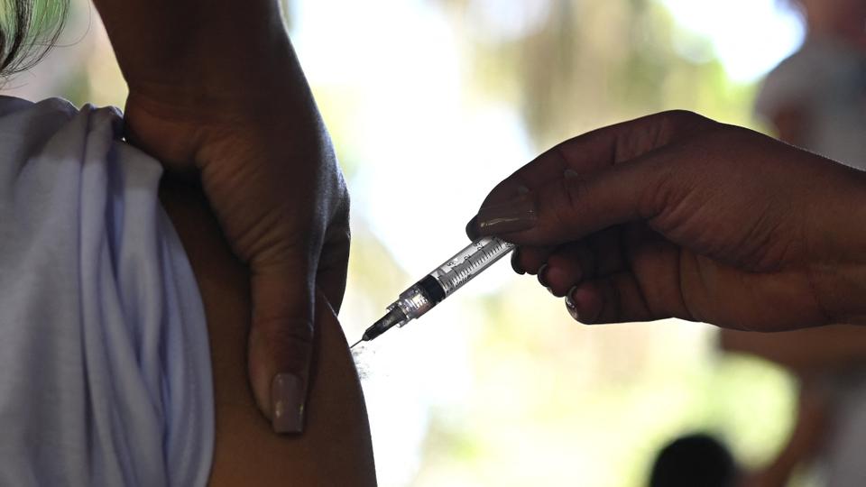 In this file photo taken on June 20, 2021, a resident receives a dose of AstraZeneca/Oxford vaccine against Covid-19 during the first day of a mass vaccination campaign within the 'paqueta vaccinated' project at Paqueta island in Rio de Janeiro, Brazil.
