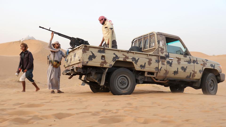 Armed men loyal to the government forces guard a site near the Safer oil fields in Marib, Yemen, on September 12, 2021.