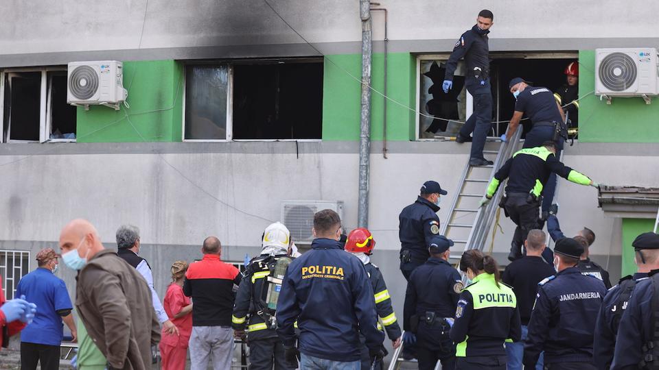Emergency personnel assist the people evacuated after a fire broke out at the intensive care unit of a Covid-19 hospital in Constanta, Romania, October 1, 2021.