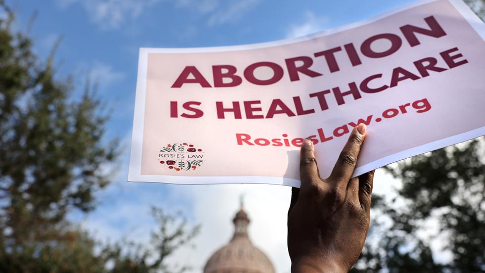 A supporter of reproductive rights holds a sign outside the Texas State Capitol building during the nationwide Women's March in Austin, Texas, US, October 2, 2021.
