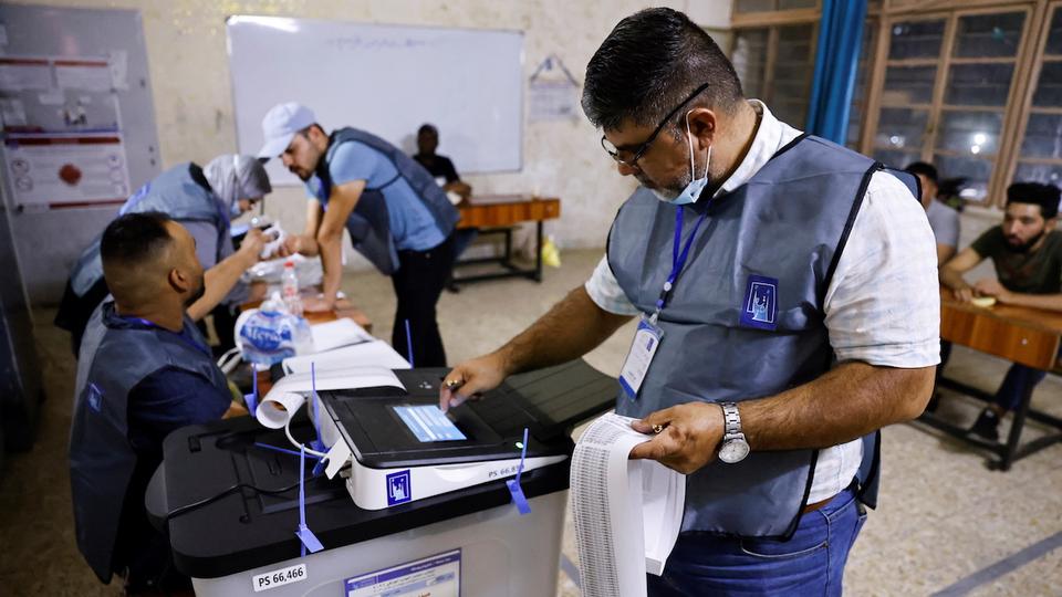 Officials work at a polling station during the parliamentary election, in Baghdad, Iraq, October 10, 2021.