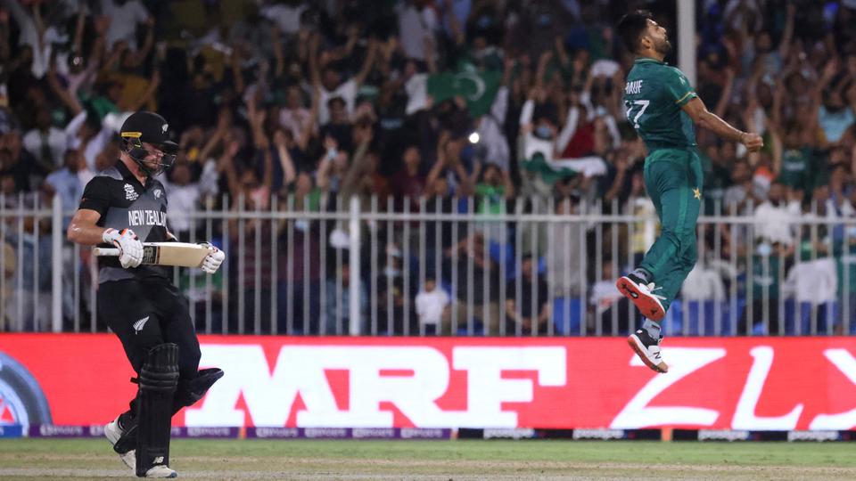 Pakistan's Haris Rauf (R) celebrates the dismissal of New Zealand's Devon Conway at the Sharjah Cricket Stadium on October 26, 2021.