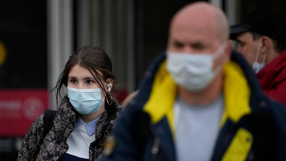 People wearing face masks to help curb the spread of the coronavirus leave a subway in Moscow, Russia,