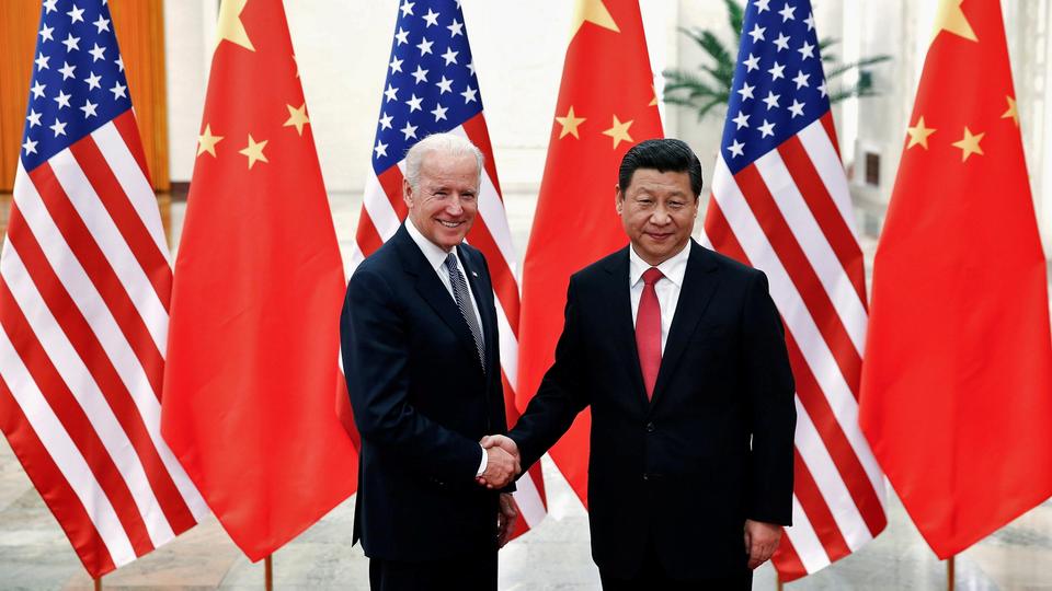 FILE PHOTO: Chinese President Xi Jinping shakes hands with U.S. Vice President Joe Biden (L) inside the Great Hall of the People in Beijing December 4, 2013.
