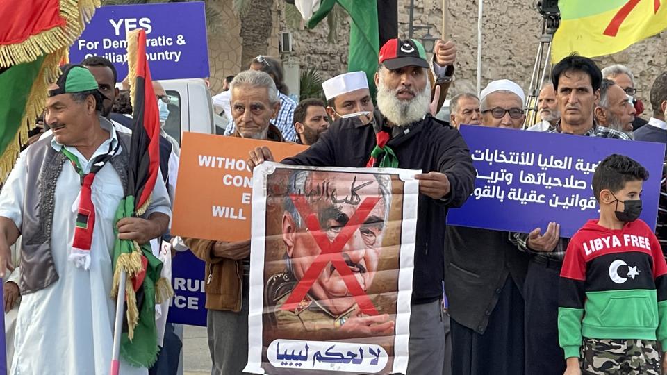 People gather to protest against the candidacy application of Saif al Islam Gaddafi, the son of former Libyan ruler Muammar Gaddafi and Khalifa Haftar for upcoming presidential election in Tripoli.