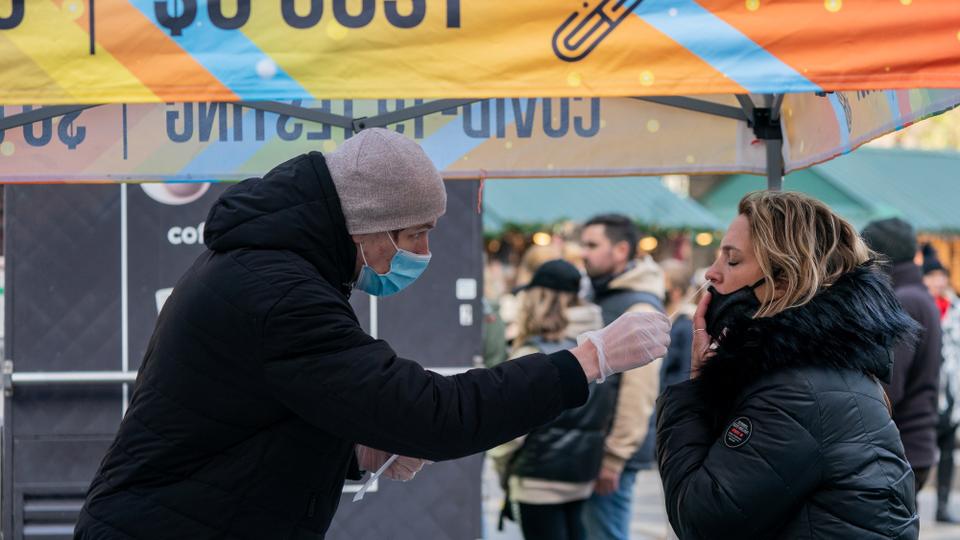 A person has a nasal swab applied for the coronavirus disease test taken at a mobile testing site in New York, U.S., December 3, 2021.