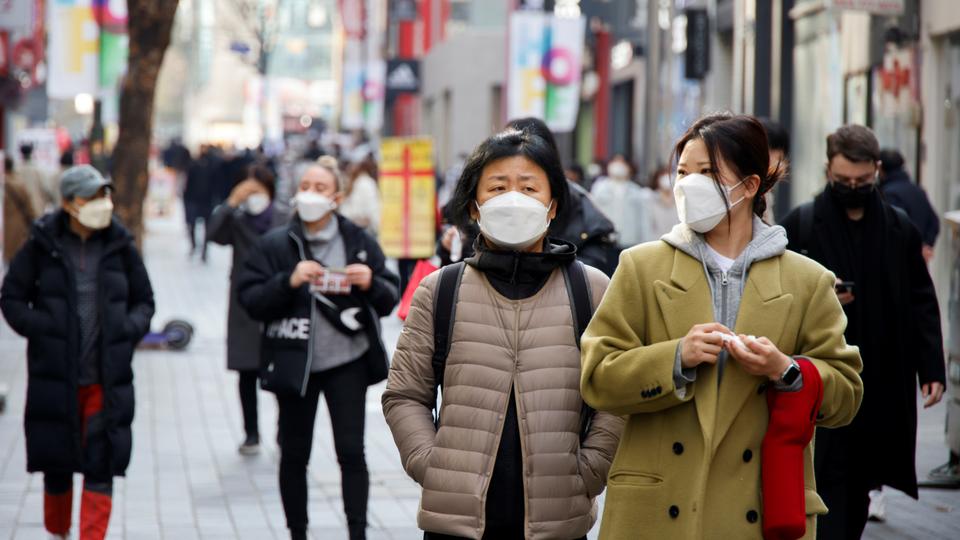 Women wearing masks walk in a shopping district amid the Covid-19 pandemic in Seoul, South Korea, November 29, 2021. REUTERS/Heo Ran