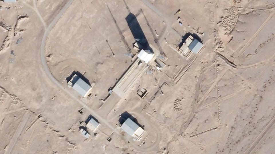 In this satellite photo by Planet Labs Inc., a support vehicle stands parked alongside a massive white gantry that typically houses a rocket on the launch pad as activity is seen at the Imam Khomeini Spaceport in Semnan province, Iran, on December 11, 2021.