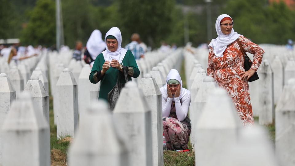 Women mourn near gravestones as the funeral ceremony for 19 victims of the Srebrenica Genocide, whose identities have been detected, held at Potocari cemetery in Srebrenica, Bosnia and Herzegovina on July 11, 2021.