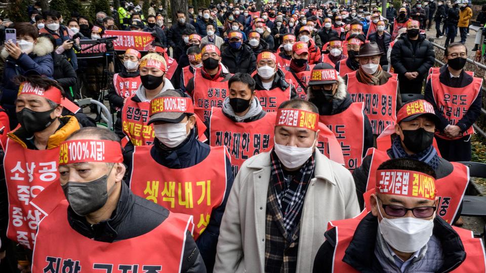 Small business owners gather during a protest against the government's Covid-19 social distancing measures in Seoul on January 25, 2022.