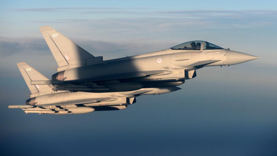 British Royal Air Force's Typhoon Eurofighter jets demonstrate the interception of a Belgian air force transport plane as they fly over Britain, January 14, 2020.