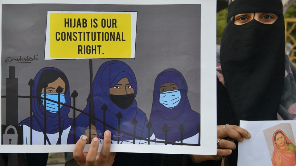 A Muslim woman holds a placard reading 'Hijab is our constitutional right' during a demonstration after educational institutes in Karnataka denied entry to students for wearing hijabs, in Bangalore on February 7, 2022.